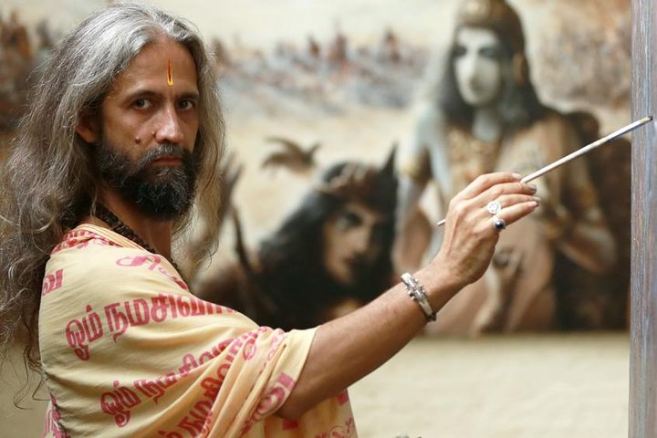 Rahju with his paintings